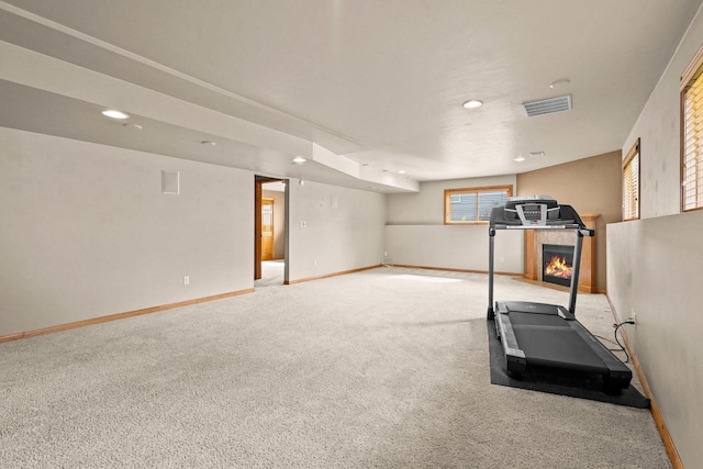 workout room featuring carpet flooring, a fireplace, baseboards, and recessed lighting