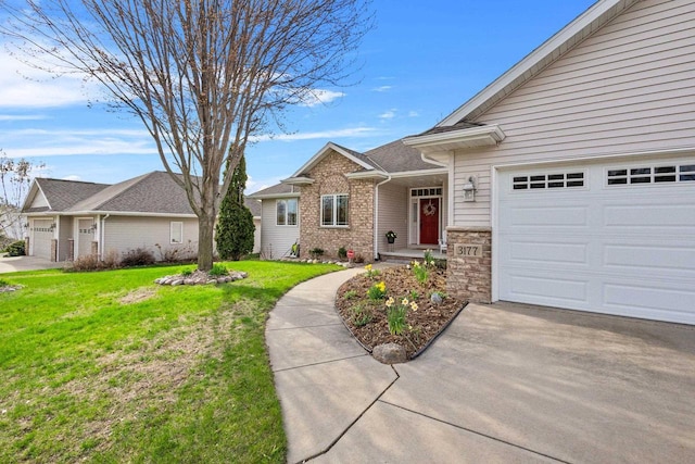 view of front of home featuring a front lawn, an attached garage, driveway, and stone siding