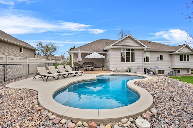 view of swimming pool with a patio area, fence, and central AC