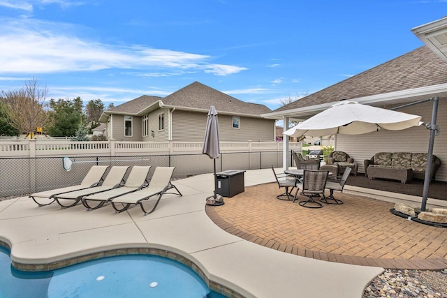 view of pool with a patio, fence, and an outdoor living space