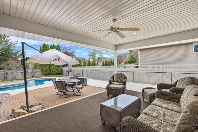 view of patio / terrace featuring a ceiling fan, a fenced backyard, and outdoor dining area