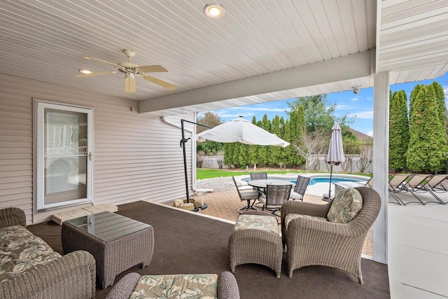 view of patio / terrace with a fenced backyard, a ceiling fan, and outdoor dining space