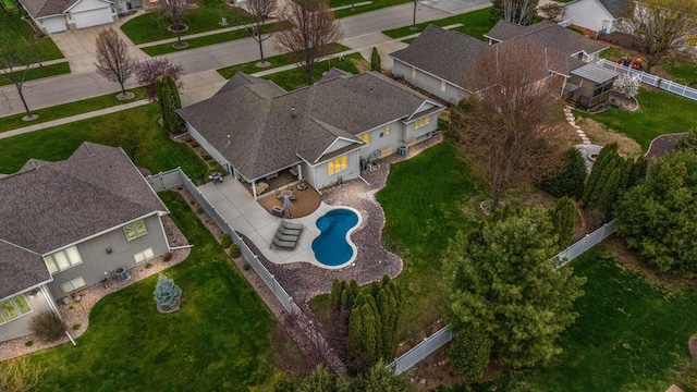 aerial view of property's location with a pool and nearby suburban area