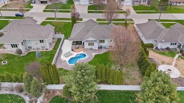 aerial overview of property's location with nearby suburban area and a pool area