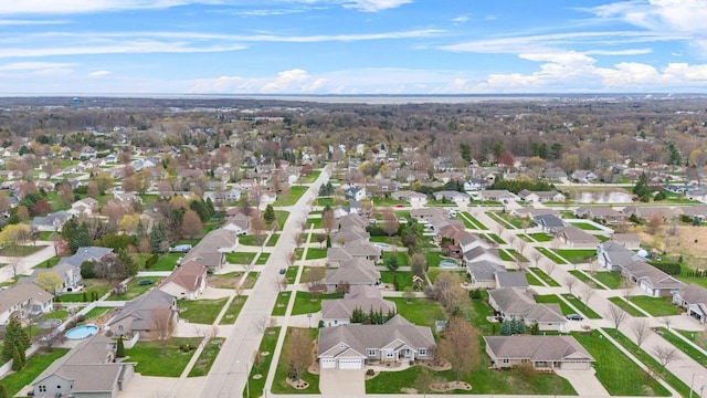 aerial view of property and surrounding area featuring nearby suburban area