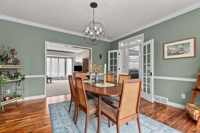 3311 S Scarlet Oak Ln, Appleton, WI 54915 - dining room featuring wood finished floors, a chandelier, baseboards, and crown molding