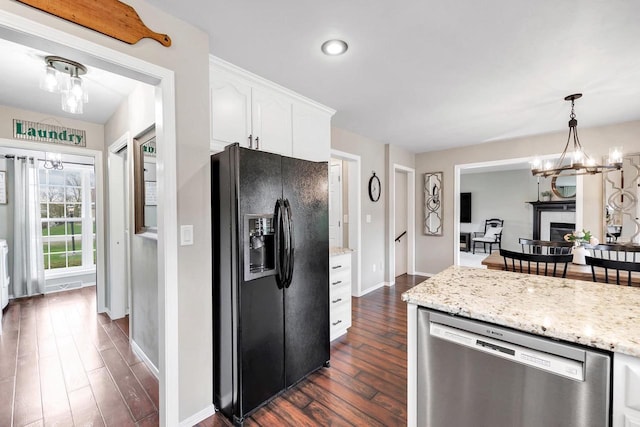 kitchen featuring black refrigerator with ice dispenser, dishwasher, dark wood-style floors, a chandelier, and white cabinetry