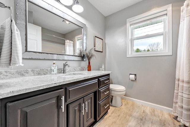 bathroom featuring baseboards, vanity, toilet, and curtained shower
