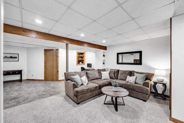 living room with baseboards, recessed lighting, carpet floors, and a drop ceiling