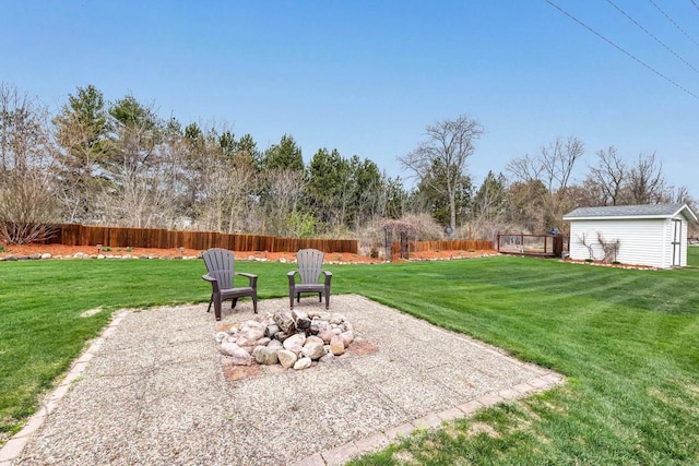 view of yard with a fire pit and an outbuilding