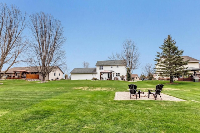 view of grassy yard featuring a gazebo and an outdoor fire pit