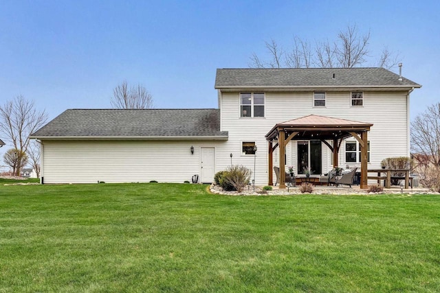 rear view of property with a gazebo, a lawn, and a patio