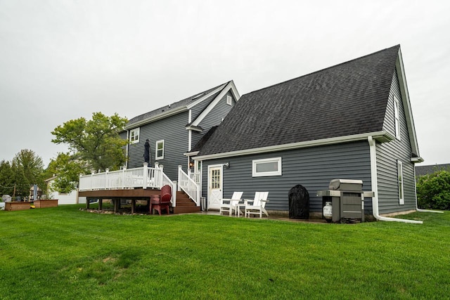 1753 Oneida Ct, Grafton, WI 53024 - back of house featuring a deck, a shingled roof, and a lawn