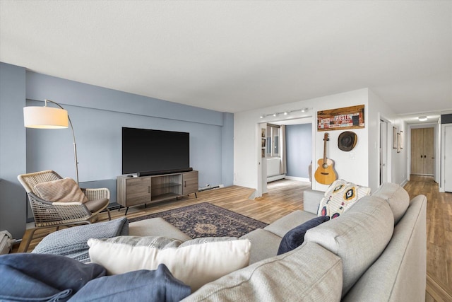 living area featuring baseboard heating and wood finished floors