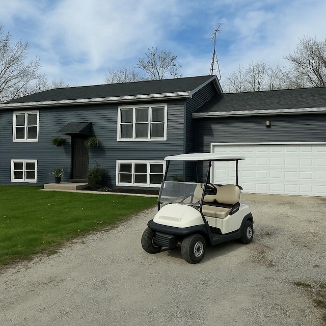 N3413 Queen Rd, Lake Geneva, WI 53147 - view of front of house featuring asphalt driveway, a garage, and a front lawn
