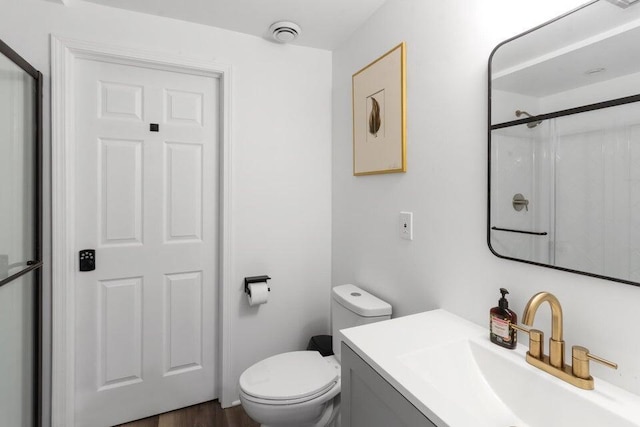 N3413 Queen Rd, Lake Geneva, WI 53147 - bathroom with toilet, a shower, vanity, and wood finished floors