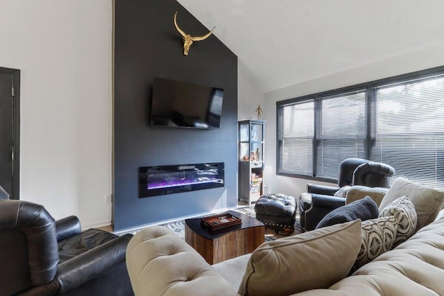 N3413 Queen Rd, Lake Geneva, WI 53147 - living room featuring lofted ceiling, baseboards, and a glass covered fireplace