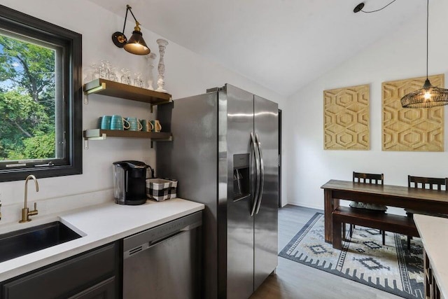 N3413 Queen Rd, Lake Geneva, WI 53147 - kitchen featuring stainless steel appliances, a sink, light countertops, lofted ceiling, and dark wood-style floors