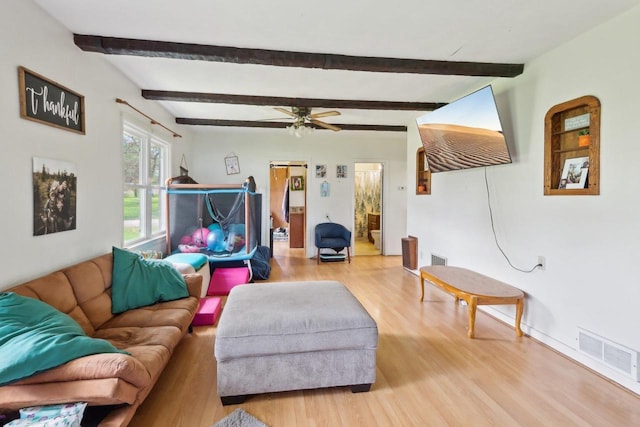 4121 1st Ave, Briggsville, WI 53920 - living room with wood finished floors, beam ceiling, a ceiling fan, and baseboards