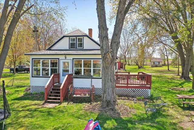 4121 1st Ave, Briggsville, WI 53920 - rear view of house featuring a deck, a yard, roof with shingles, and a chimney