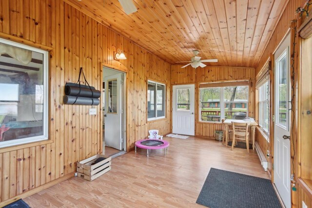 4121 1st Ave, Briggsville, WI 53920 - sunroom / solarium featuring wooden walls, wood finished floors, vaulted ceiling, a baseboard radiator, and wooden ceiling