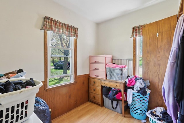 4121 1st Ave, Briggsville, WI 53920 - bedroom with multiple windows, light wood finished floors, wainscoting, and wooden walls