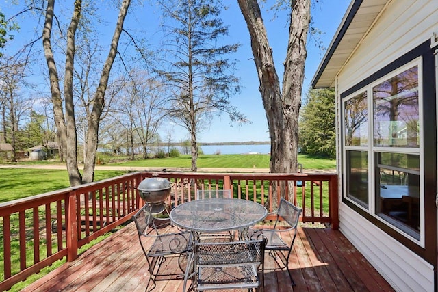 4121 1st Ave, Briggsville, WI 53920 - wooden deck with a water view, outdoor dining space, and a lawn