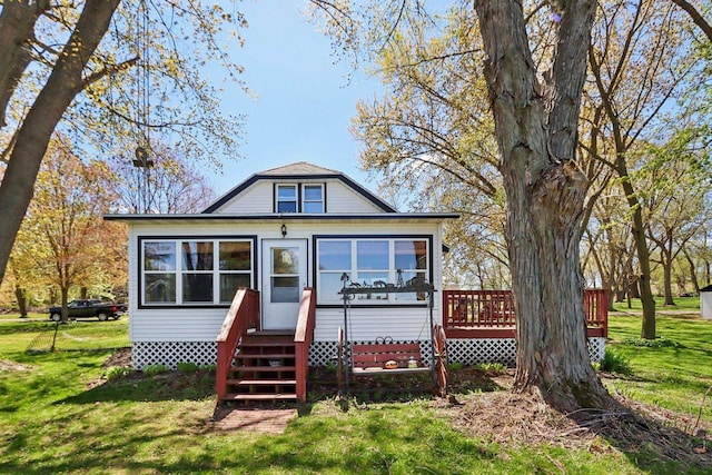 4121 1st Ave, Briggsville, WI 53920 - rear view of property with a yard, a wooden deck, and a sunroom
