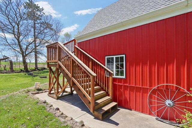 4121 1st Ave, Briggsville, WI 53920 - doorway to property with roof with shingles and a yard
