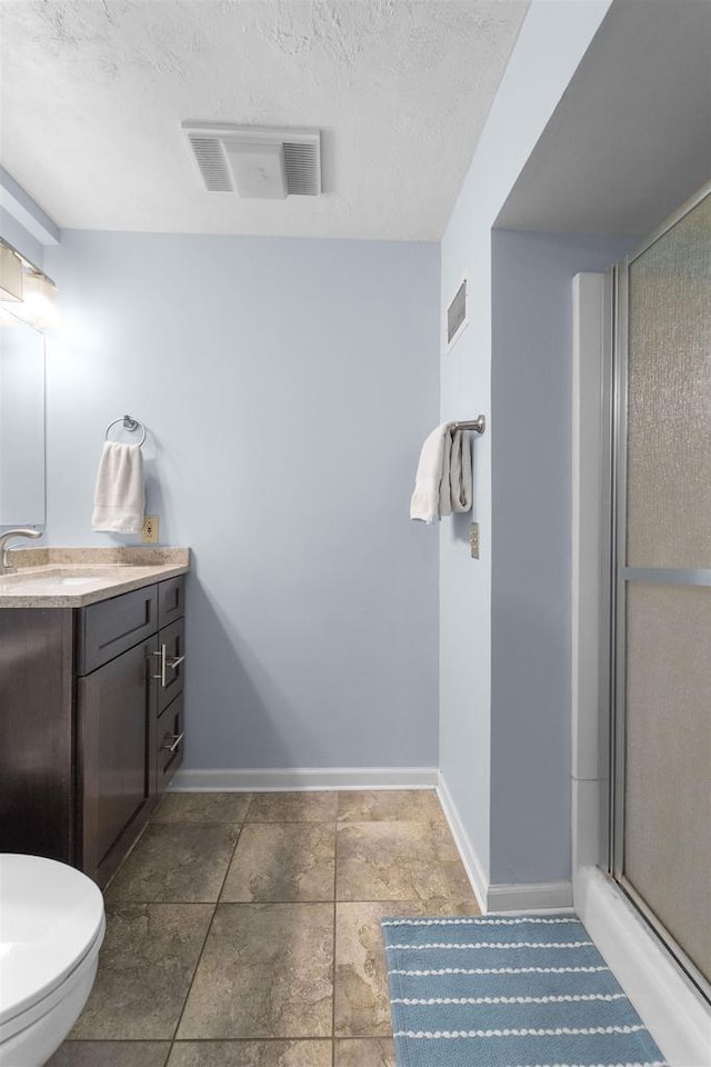 5719 Highland Way, Middleton, WI 53562 - bathroom with a stall shower, vanity, baseboards, toilet, and a textured ceiling