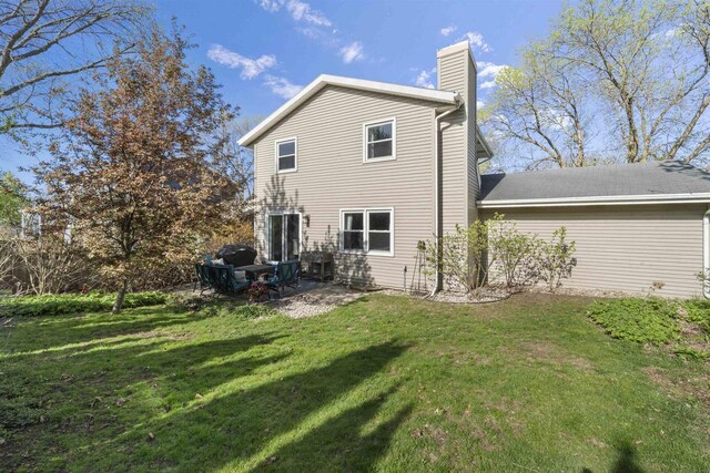 5719 Highland Way, Middleton, WI 53562 - back of property with a chimney, a lawn, and a patio