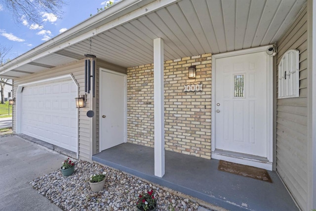 5719 Highland Way, Middleton, WI 53562 - entrance to property featuring brick siding, a garage, and covered porch