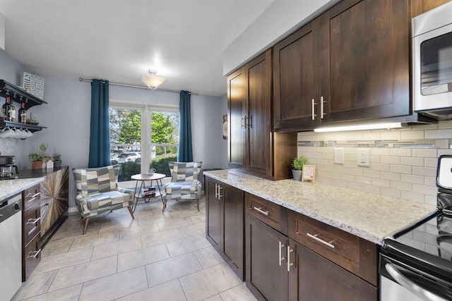 5719 Highland Way, Middleton, WI 53562 - kitchen featuring appliances with stainless steel finishes, decorative backsplash, open shelves, dark brown cabinets, and light stone countertops