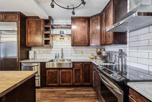 6941 Chester Dr Unit C, Madison, WI 53719 - kitchen with stainless steel appliances, wall chimney exhaust hood, a sink, butcher block countertops, and dark wood-style floors