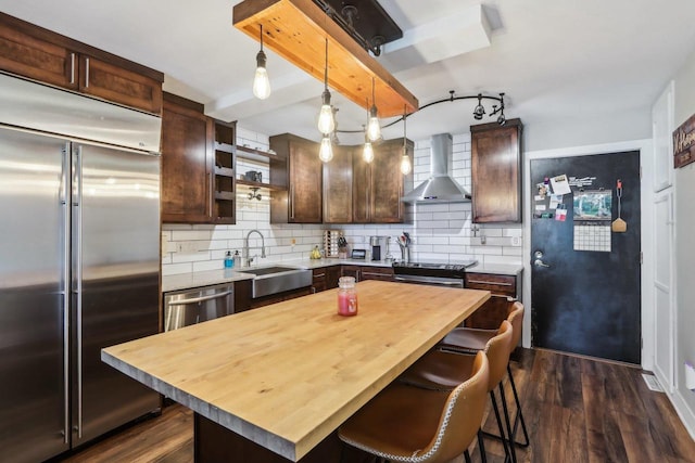 6941 Chester Dr Unit C, Madison, WI 53719 - kitchen with stainless steel appliances, a sink, wall chimney exhaust hood, wooden counters, and dark brown cabinetry
