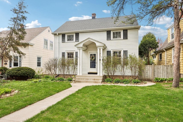 colonial inspired home featuring a chimney