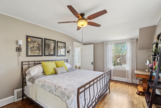 bedroom with baseboards, wood finished floors, lofted ceiling, and a ceiling fan