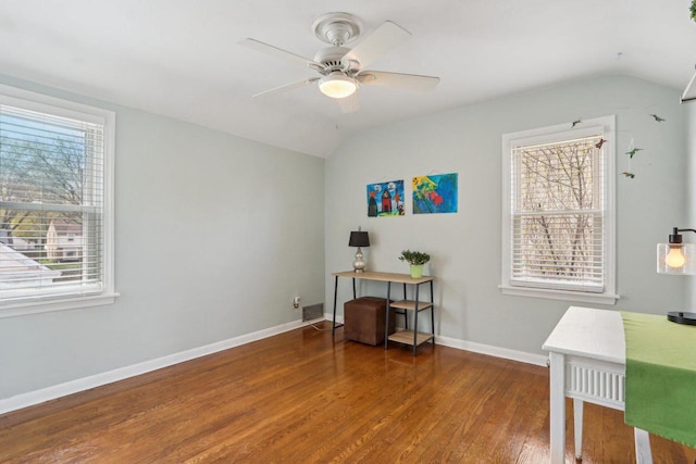 office space featuring lofted ceiling, wood finished floors, a ceiling fan, and baseboards