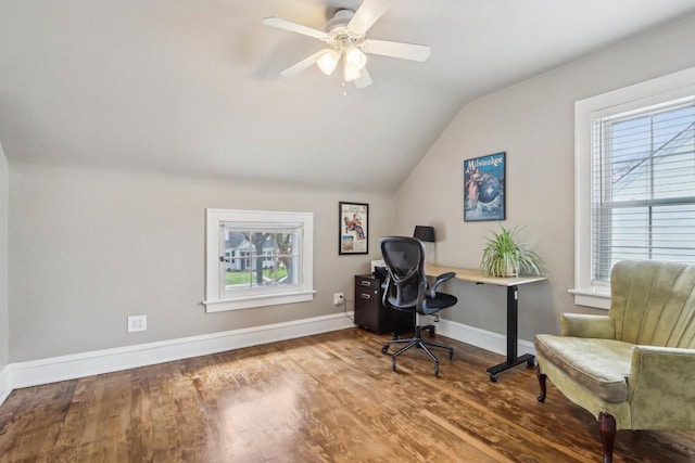 office featuring lofted ceiling, healthy amount of natural light, wood finished floors, a ceiling fan, and baseboards