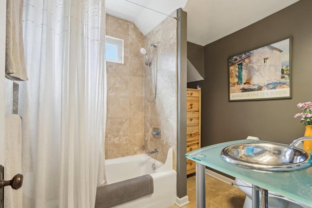 full bath featuring shower / tub combo with curtain, tile patterned floors, and vaulted ceiling