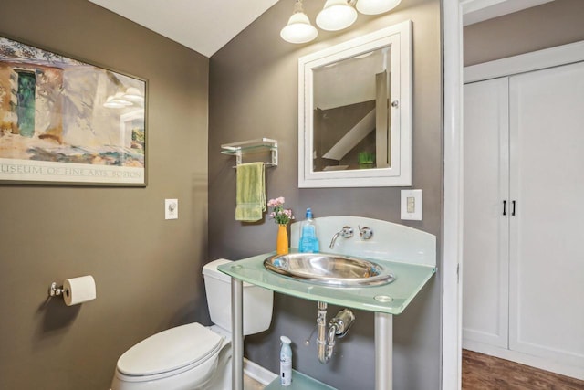 half bath with toilet and a sink
