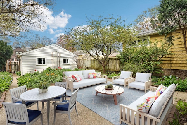 view of patio with an outdoor hangout area, fence, an outdoor structure, and outdoor dining area