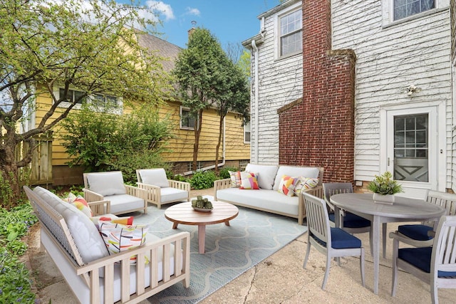 view of patio featuring outdoor lounge area and fence