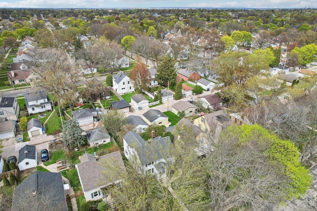 aerial view of property and surrounding area featuring nearby suburban area