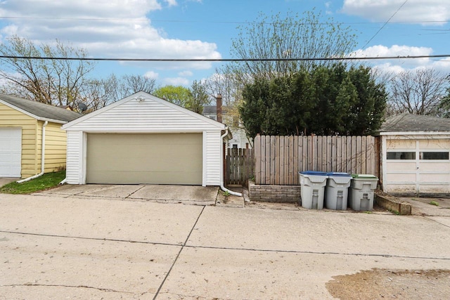 detached garage featuring fence