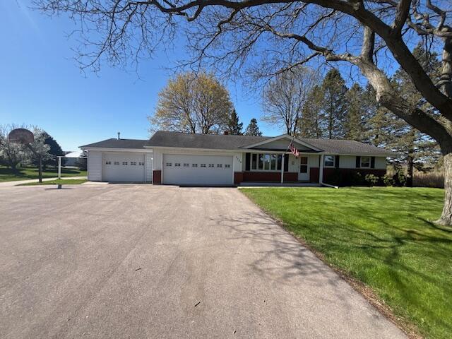 7704 Salisbury Rd, West Bend, WI 53090 - single story home featuring asphalt driveway, a garage, and a front yard