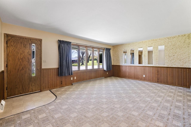 7704 Salisbury Rd, West Bend, WI 53090 - unfurnished living room featuring wainscoting, baseboard heating, and wood walls