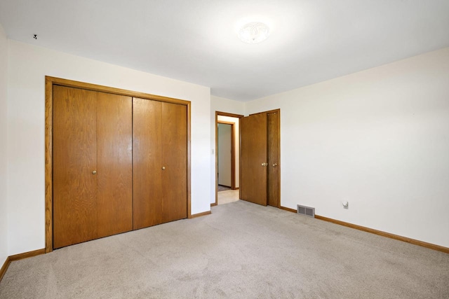 7704 Salisbury Rd, West Bend, WI 53090 - unfurnished bedroom featuring light colored carpet, baseboards, and a closet