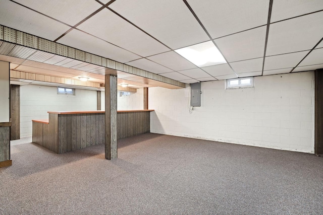 7704 Salisbury Rd, West Bend, WI 53090 - basement with a bar, carpet flooring, a paneled ceiling, concrete block wall, and electric panel