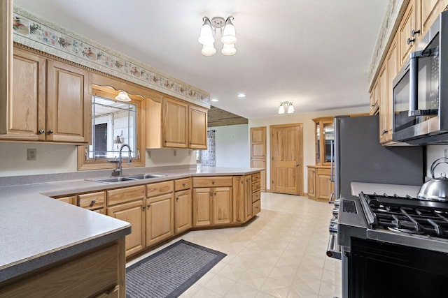 7704 Salisbury Rd, West Bend, WI 53090 - kitchen featuring a sink, stainless steel microwave, a peninsula, recessed lighting, and light flooring
